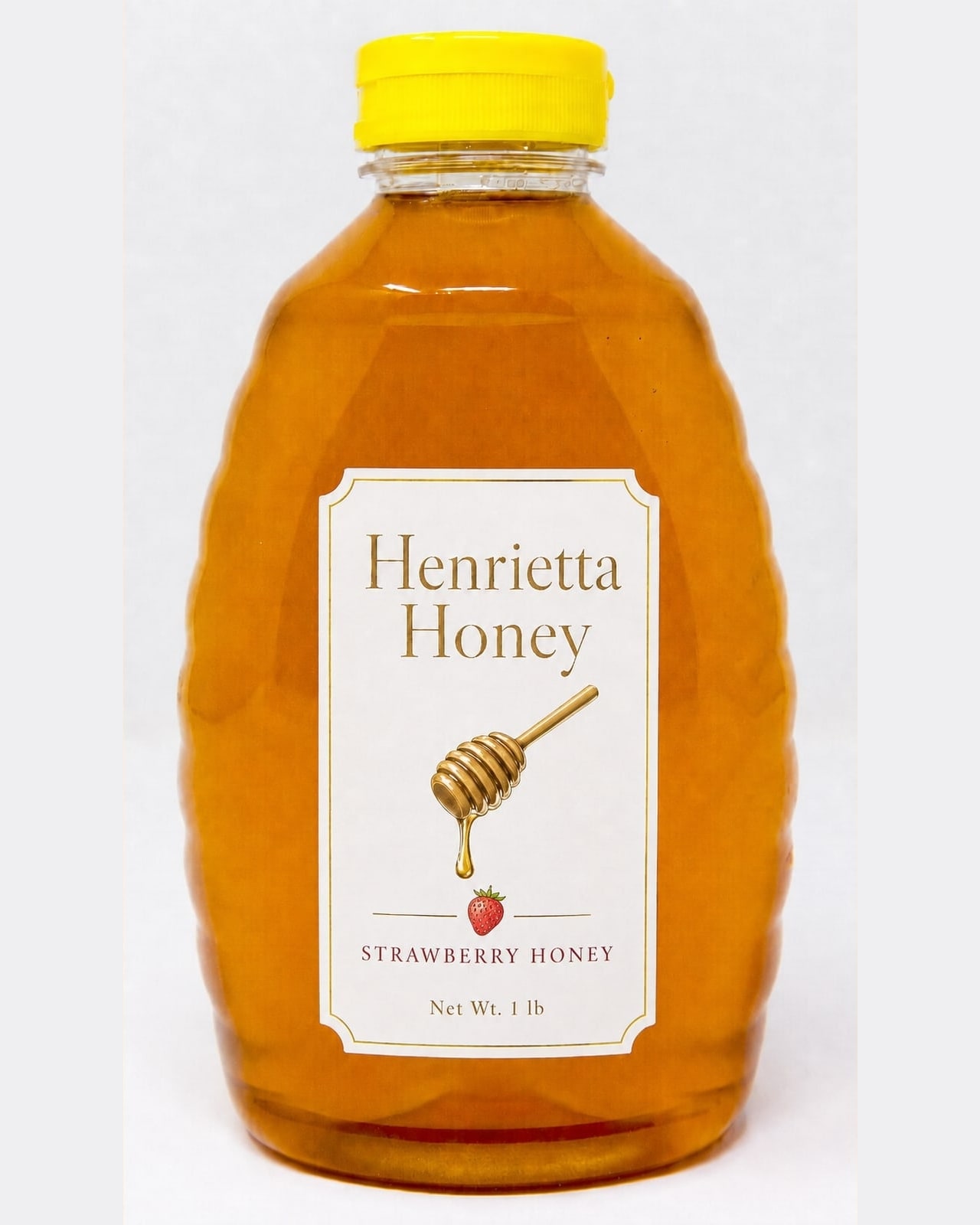 A 1 lb bottle of Henrietta Honey strawberry infused honey with a gold foil label